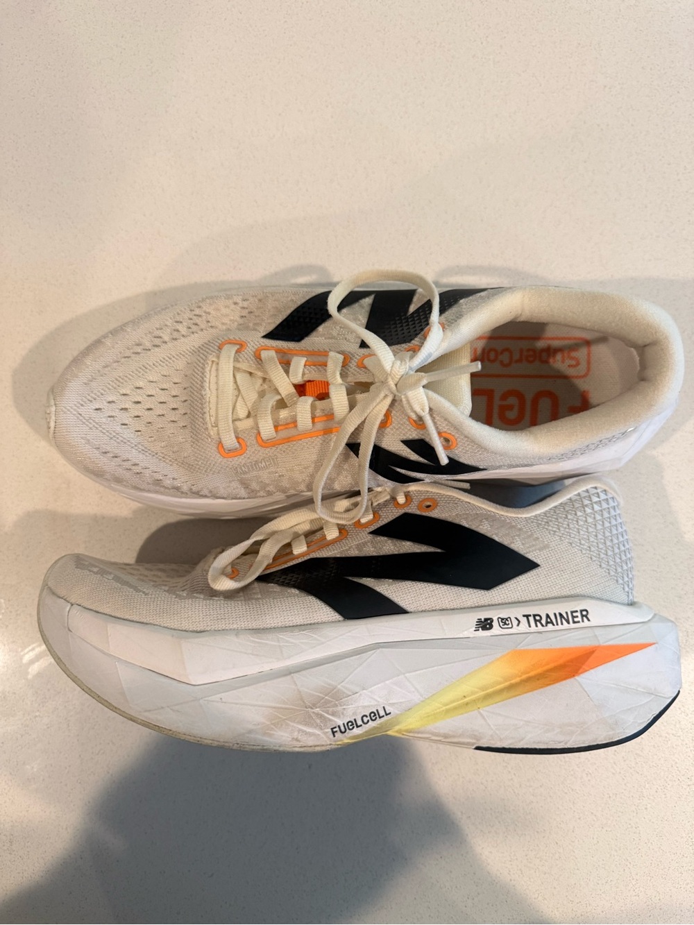 New Balance White Athletic Trainer with Black Logo and Orange Accents